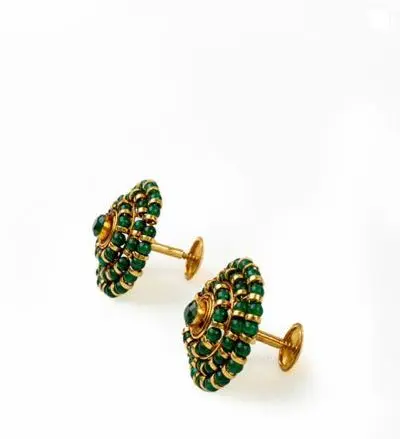 Round gold earrings set with rings of green jade beads.